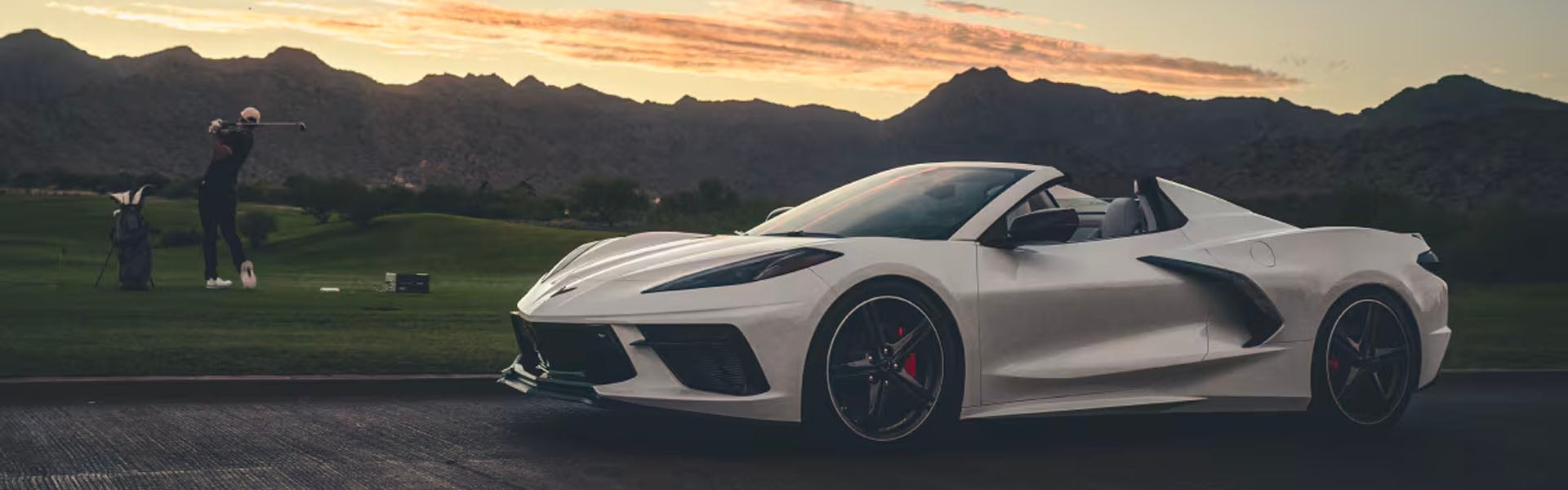 A white sports car parked on a road